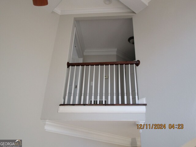 unfurnished dining area with a raised ceiling, light tile patterned floors, a chandelier, and ornamental molding