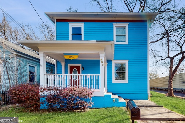 view of front facade with a porch and a front lawn