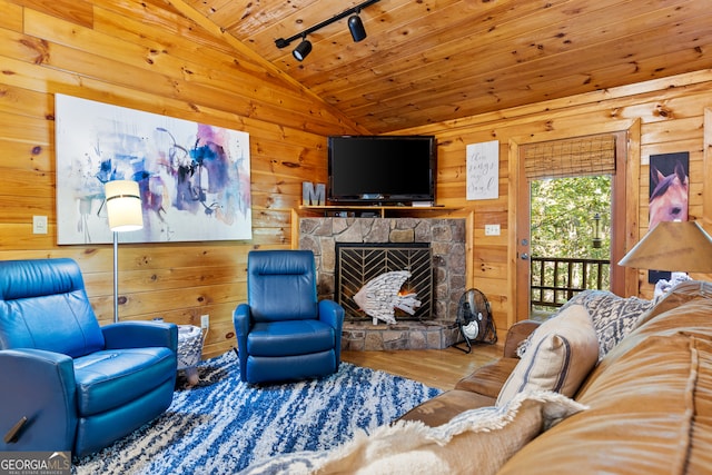 living room with wood-type flooring, lofted ceiling, wood walls, a fireplace, and wooden ceiling