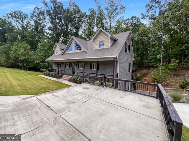 view of front of house with a front yard and covered porch