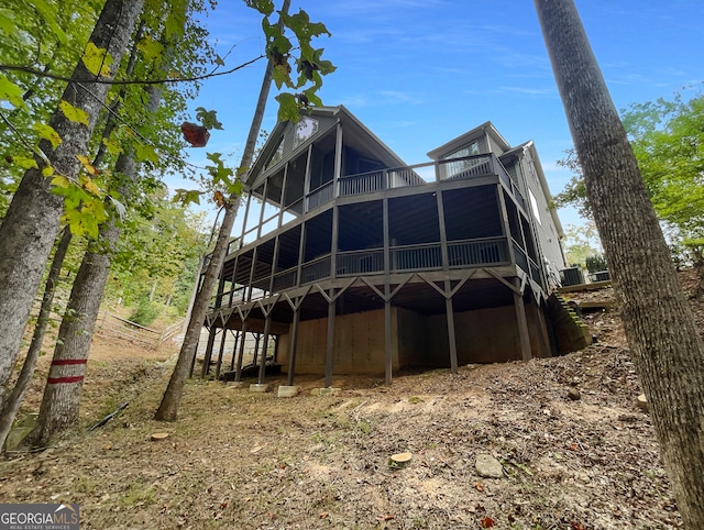 rear view of house featuring a deck and a sunroom