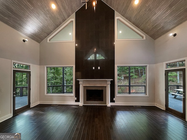 unfurnished living room featuring high vaulted ceiling and a healthy amount of sunlight