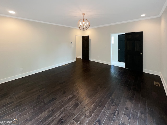 unfurnished room with ornamental molding, dark wood-type flooring, and a chandelier