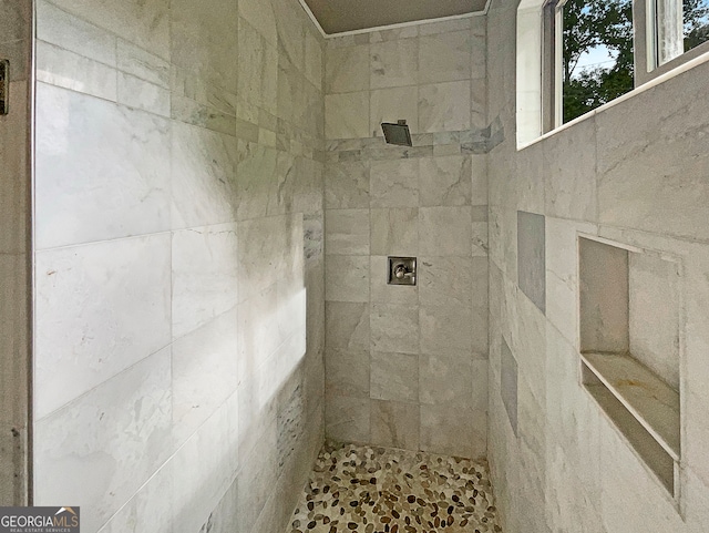 bathroom with tiled shower