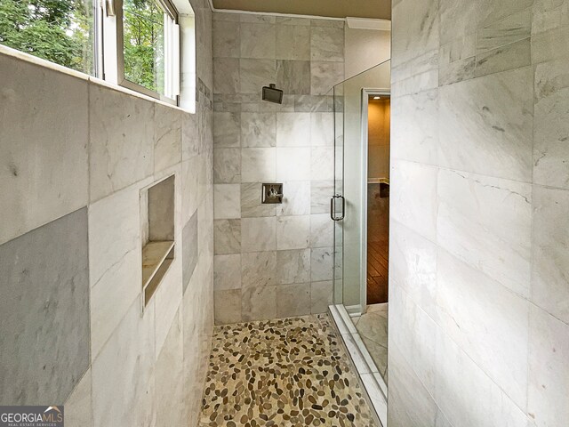 bathroom with a shower with shower door