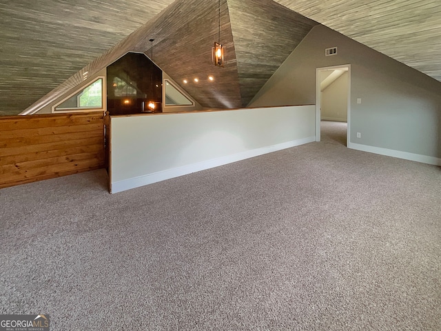 bonus room with lofted ceiling and carpet flooring