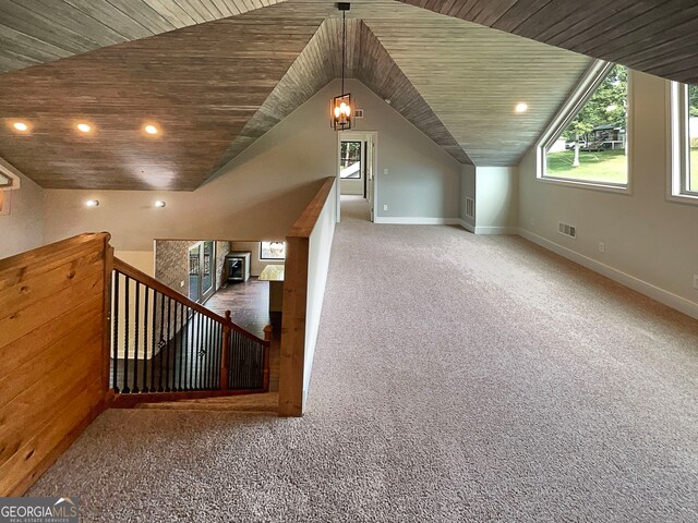 additional living space featuring wooden ceiling, vaulted ceiling, and carpet floors