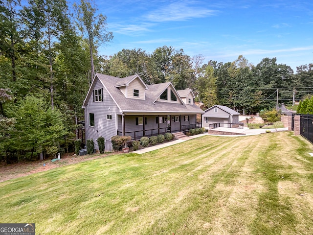 back of house featuring a garage, a porch, and a lawn