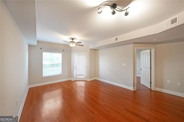 unfurnished living room with wood finished floors, ceiling fan, and baseboards