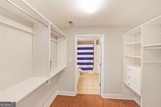 spacious closet featuring wood finished floors
