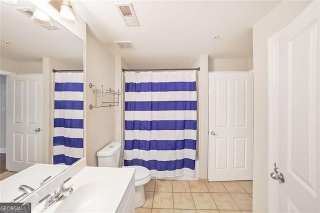 full bathroom featuring toilet, tile patterned floors, vanity, and curtained shower