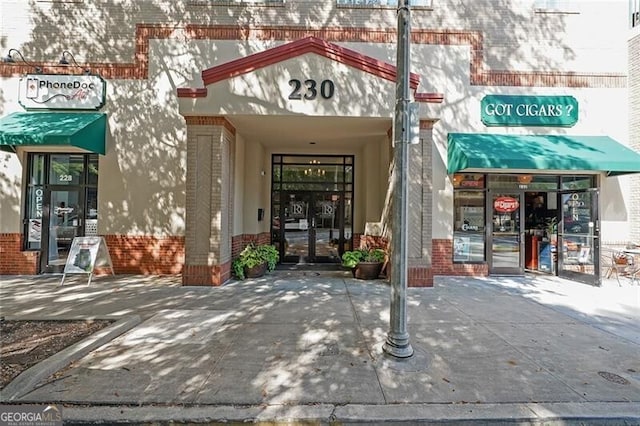 doorway to property with brick siding