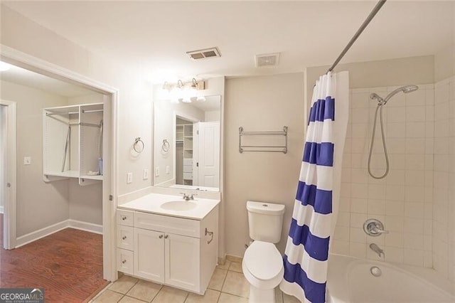 full bathroom featuring shower / bath combo, vanity, tile patterned flooring, and baseboards