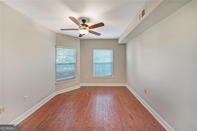 empty room featuring ceiling fan, wood finished floors, and baseboards
