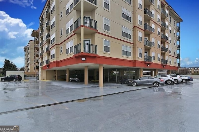 view of apartment building / complex featuring uncovered parking