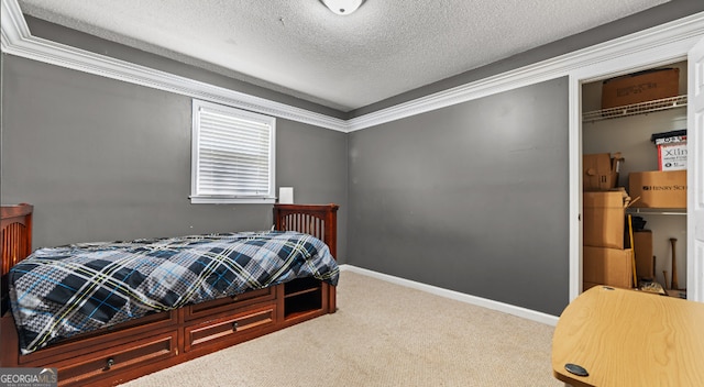 carpeted bedroom featuring a textured ceiling, ornamental molding, and a closet