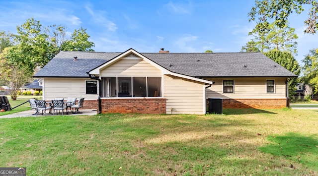 rear view of property featuring a patio, cooling unit, a yard, and a sunroom