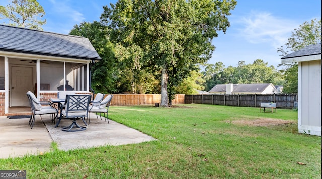 view of yard with a sunroom and a patio area