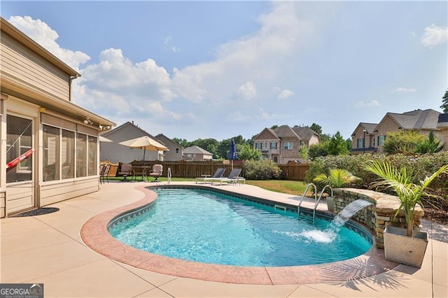 view of swimming pool featuring a patio, a fenced backyard, a sunroom, a residential view, and a fenced in pool