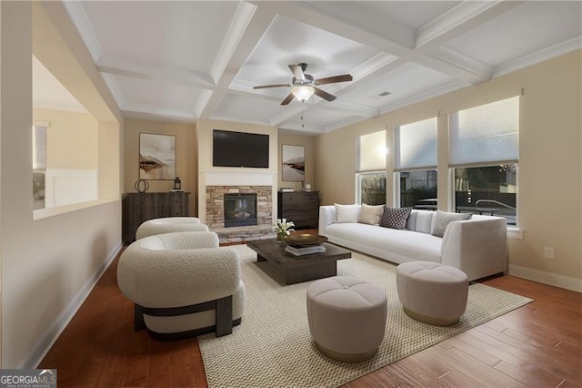 living area with a stone fireplace, beamed ceiling, coffered ceiling, and wood finished floors