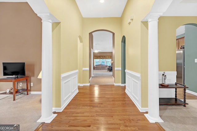 hallway with ornate columns and a decorative wall