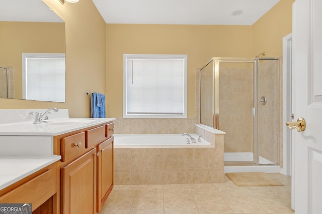 bathroom with a stall shower, tile patterned flooring, a bath, and vanity