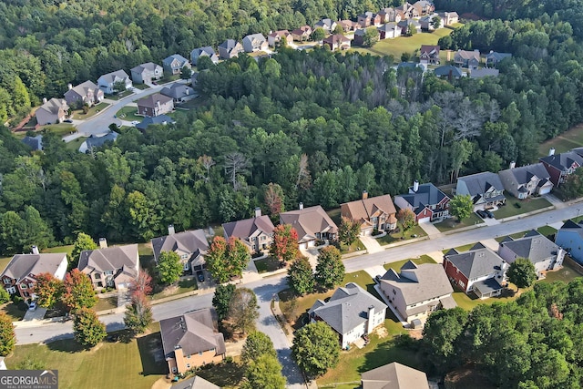 birds eye view of property with a wooded view and a residential view