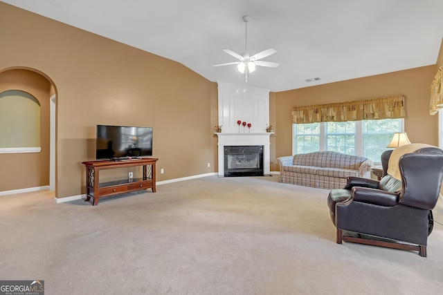 living room with vaulted ceiling, a large fireplace, visible vents, and light colored carpet