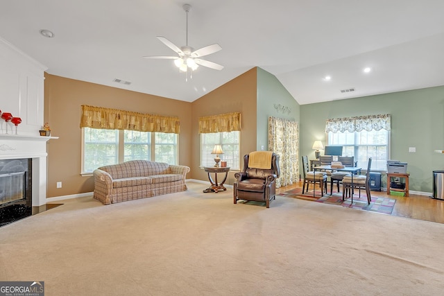 living room featuring carpet, a fireplace, and visible vents