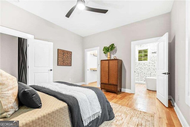 bedroom featuring ceiling fan, light wood-type flooring, and ensuite bath