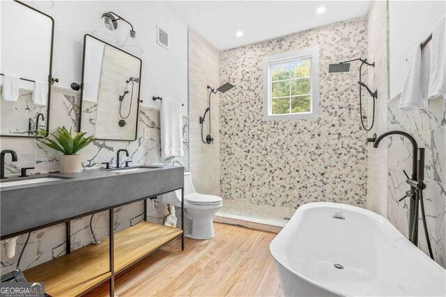 full bathroom with vanity, separate shower and tub, hardwood / wood-style floors, and toilet