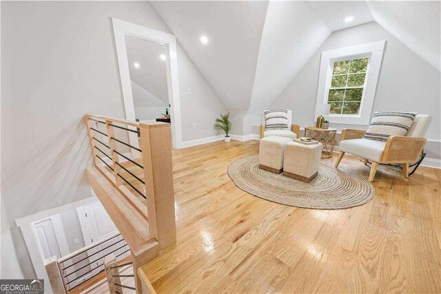 sitting room featuring lofted ceiling and light hardwood / wood-style flooring