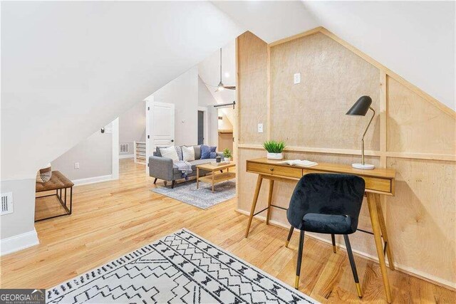 office space with wood-type flooring and vaulted ceiling