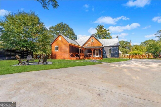 view of front of house with a front yard and a fire pit