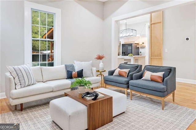 living room featuring a chandelier and light hardwood / wood-style floors