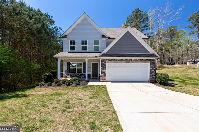 view of front of property with a front yard, a garage, and covered porch