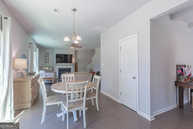 dining space with ceiling fan and dark hardwood / wood-style floors