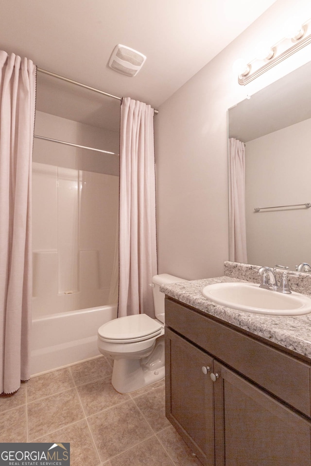 full bathroom featuring vanity, tile patterned floors, toilet, and shower / tub combo with curtain