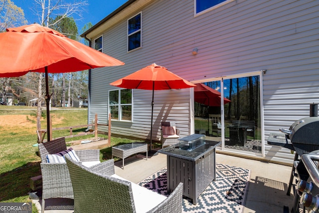 view of patio / terrace with area for grilling and an outdoor living space with a fire pit