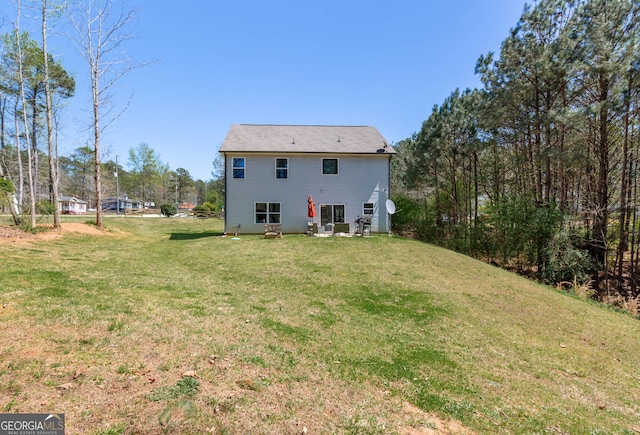 rear view of property with a yard