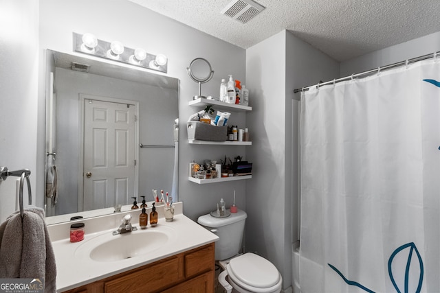 full bathroom with shower / bath combo with shower curtain, a textured ceiling, vanity, and toilet