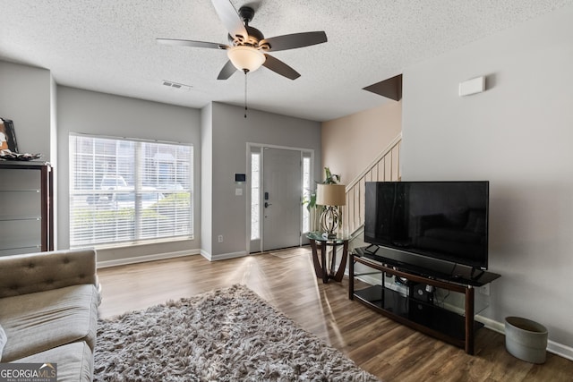 2783 Parkway Cv, Lithonia, GA 30058 - living area with wood finished floors, a textured ceiling, and visible vents