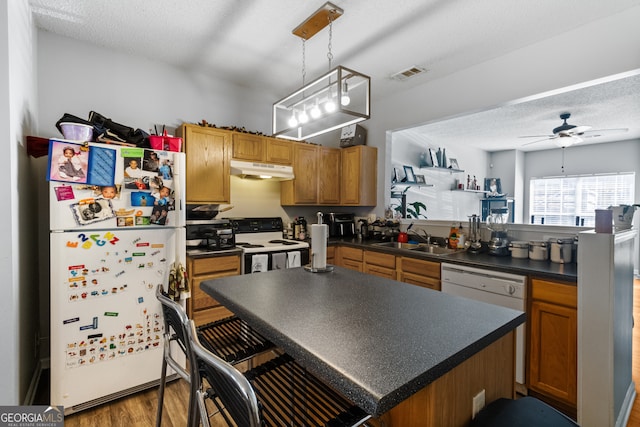 kitchen with ceiling fan, hanging light fixtures, sink, white appliances, and hardwood / wood-style floors