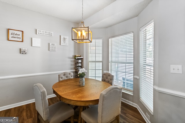 dining space with a notable chandelier, dark hardwood / wood-style flooring, and a textured ceiling