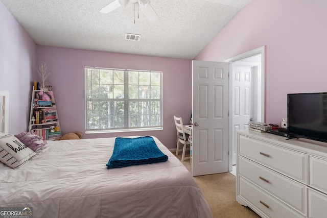 carpeted bedroom featuring lofted ceiling, ceiling fan, and a textured ceiling