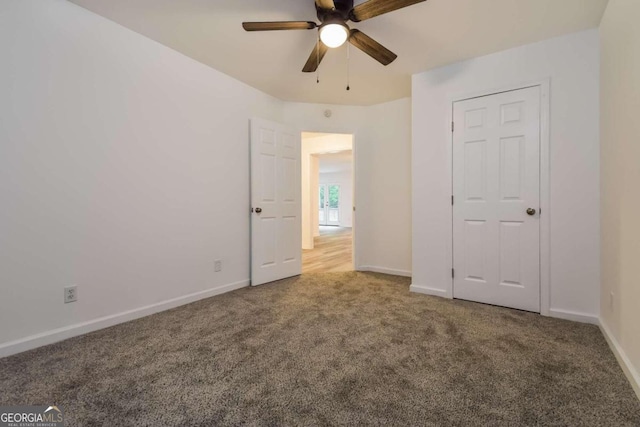 unfurnished bedroom with ceiling fan and carpet