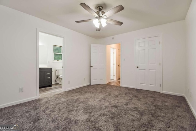 unfurnished bedroom featuring ceiling fan, light colored carpet, and ensuite bathroom