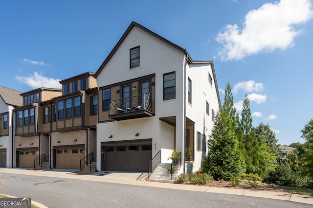 view of front of home with a balcony and a garage