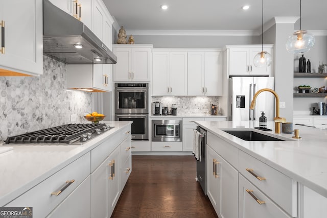 kitchen with appliances with stainless steel finishes, decorative light fixtures, and white cabinets