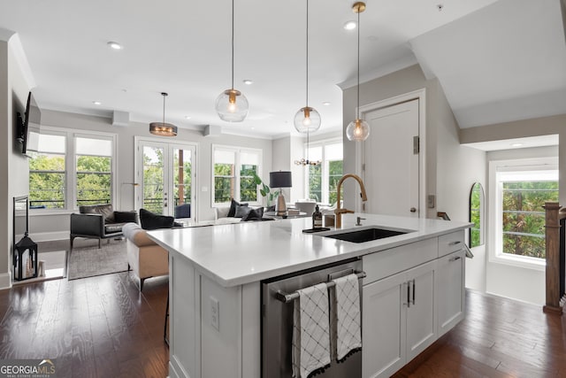 kitchen with pendant lighting, a center island with sink, sink, and a healthy amount of sunlight